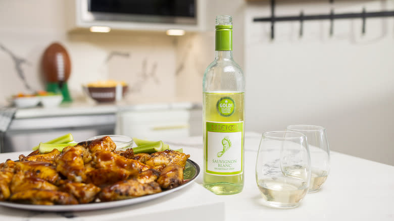 Bottle of Barefoot wine with chicken wings