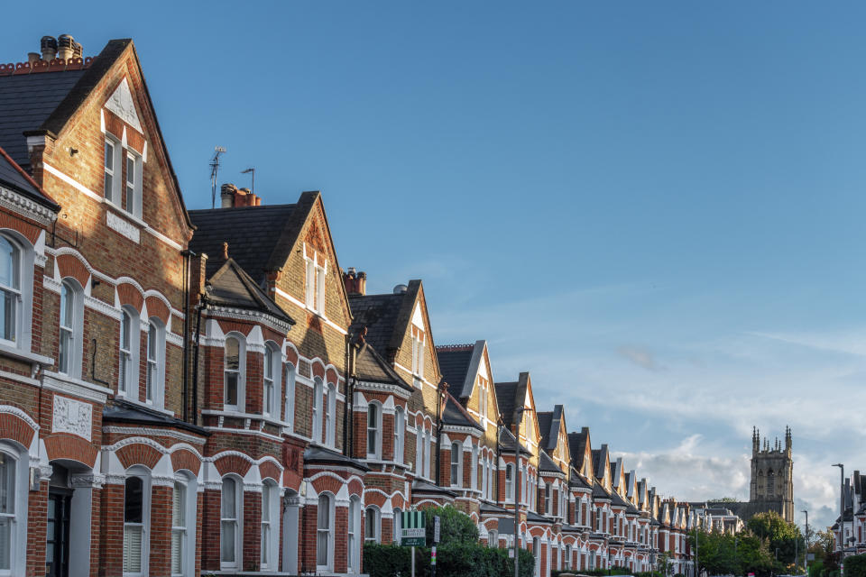 Rent Clapham, London, Lavender Gardens SW11, a row of large brick terraced houses, 19th century Victorian architecture, copy room with clear blue sky, church tower in the distance, no people