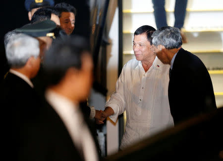 Philippine President Rodrigo Duterte (2nd R) arrives at Haneda international airport in Tokyo, Japan October 25, 2016. REUTERS/Issei Kato