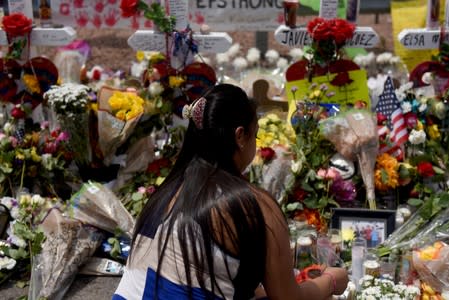 People pay their respects three days after a mass shooting in El Paso