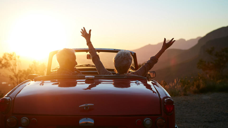 Shot of a joyful senior couple enjoying the sunset during a roadtrip.