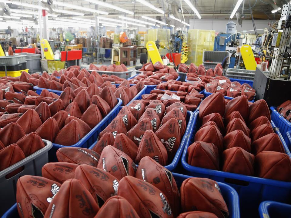 Footballs wait to be stamped with the opponents names for Super Bowl XLVIII at the Wilson Sporting Goods football factory in Ada, Ohio.