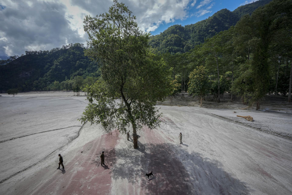 Indian army personnel search arms and ammunition that got washed away in the flood affected area along the Teesta river in Rongpo, east Sikkim, India, Sunday, Oct. 8. 2023. Rescuers continued to dig through slushy debris and ice-cold water in a hunt for survivors after a glacial lake burst through a dam in India’s Himalayan northeast, shortly after midnight Wednesday, washing away houses and bridges and forcing thousands to flee. (AP Photo/Anupam Nath)