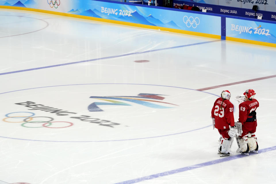 Russian Olympic Committee goalkeepers Daria Gredzen (23) and Maria Sorokina (69) wait on the ice for the scheduled start of a preliminary round women's hockey game between Russian Olympic Committee and Canada at the 2022 Winter Olympics, Monday, Feb. 7, 2022, in Beijing. Team Canada did not take the ice and an announcement was made that the game was being delayed. (AP Photo/Mark Humphrey)