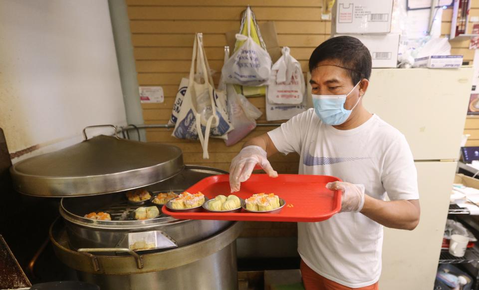 Maung Maung loads dim sum into a steamer at his restaurant, 007 Chinese Food, in Buffalo.