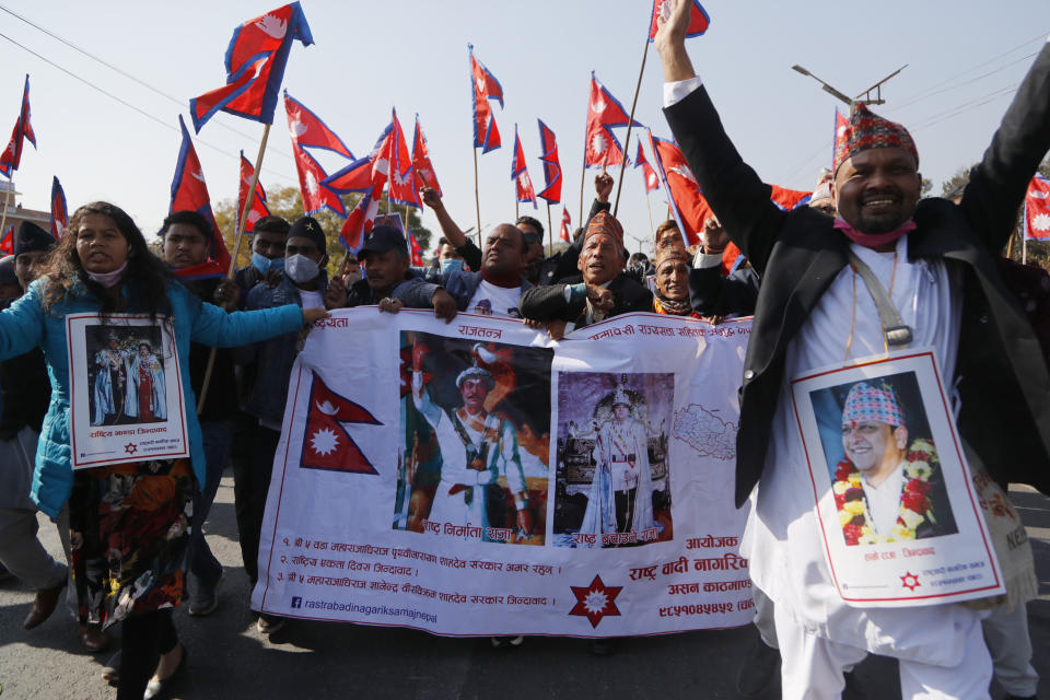 Pro-king supporters march demanding reinstating monarchy that was abolished more than a decade ago in Kathmandu, Nepal, Monday, Jan.11, 2021. Monday's protest was the latest anti-government protest against Prime Minister Khadga Prasad Oli who has been facing street demonstrations against him from a splinter faction of his own Communist party and more from opposition political groups for dissolving parliament. Nepal's centuries-old monarchy was abolished in 2008 by the parliament and replaced by a republic where the president was elected as the head of state. (AP Photo/Niranjan Shrestha)