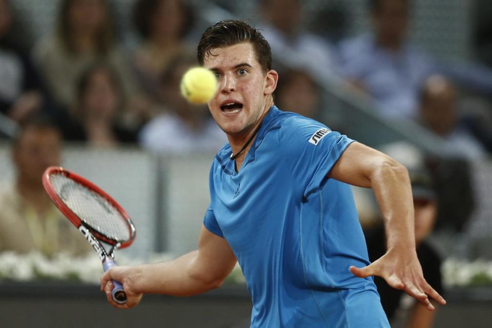 Dominic Thiem from Austria returns the ball during a Madrid Open tennis tournament match against Stanislas Wawrinka from Switzerland, in Madrid, Spain, Tuesday, May 6, 2014. (AP Photo/Andres Kudacki)