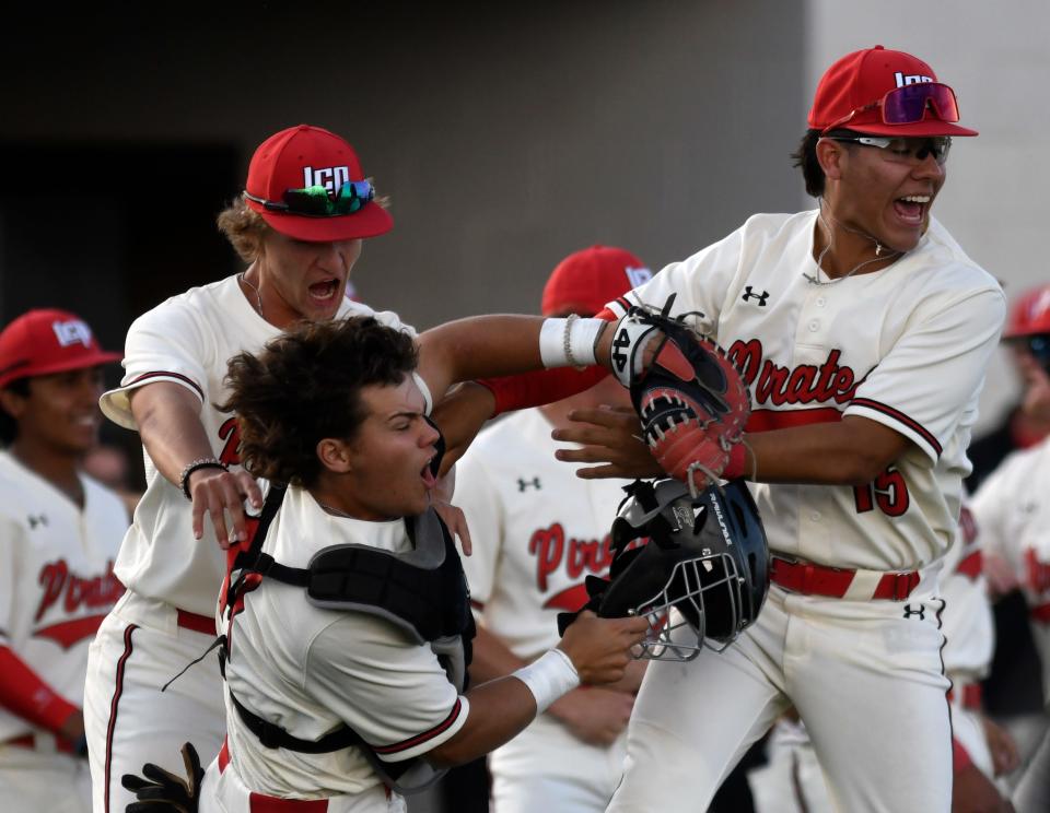 Lubbock-Cooper's Connor Sanderson, left, and Lubbock-CooperÕs Noah Williams celebrate an out against Abilene High in a District 4-5A baseball game, Tuesday, April 25, 2023, at First United Park in Woodrow.