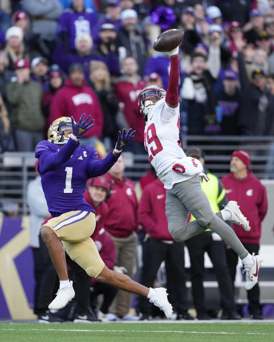Washington State defensive back Jamorri Colson swats away a pass meant for Washington wide receiver Rome Odunze during the first half of an NCAA college football game, Saturday, Nov. 25, 2023, in Seattle. (AP Photo/Lindsey Wasson)