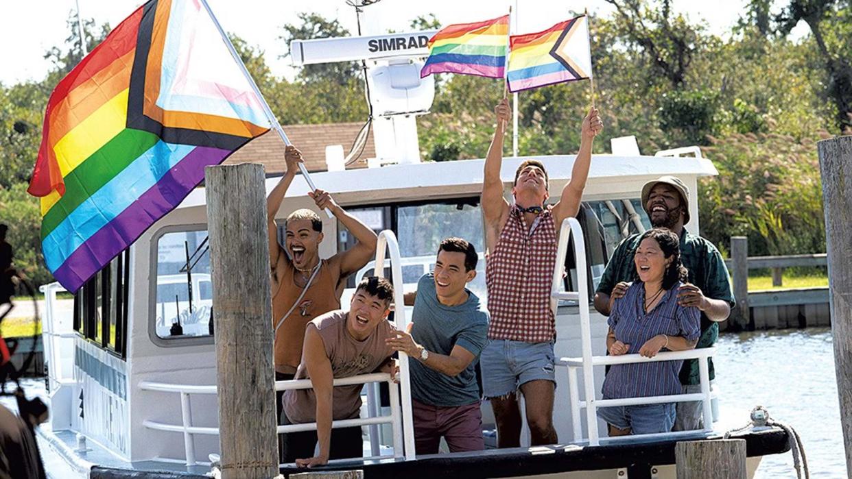  The cast of Fire Island waves rainbow flags from a boat 