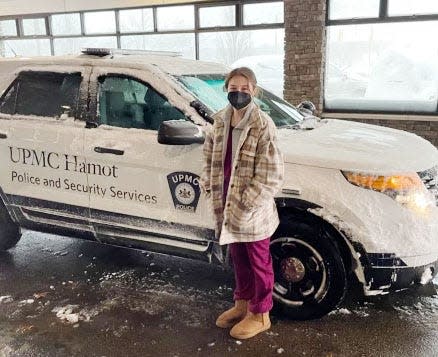 An unidentified UPMC Hamot employee arrives for work Monday morning in a Hamot police and security services vehicle. Due to a crippling snowfall, about a dozen UPMC Hamot employees were given rides to the medical facility.