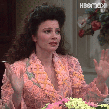 Fran Drescher in a knitted, floral-patterned sweater, gesturing with her hands at a table with flowers; HBO Max logo in the top right corner