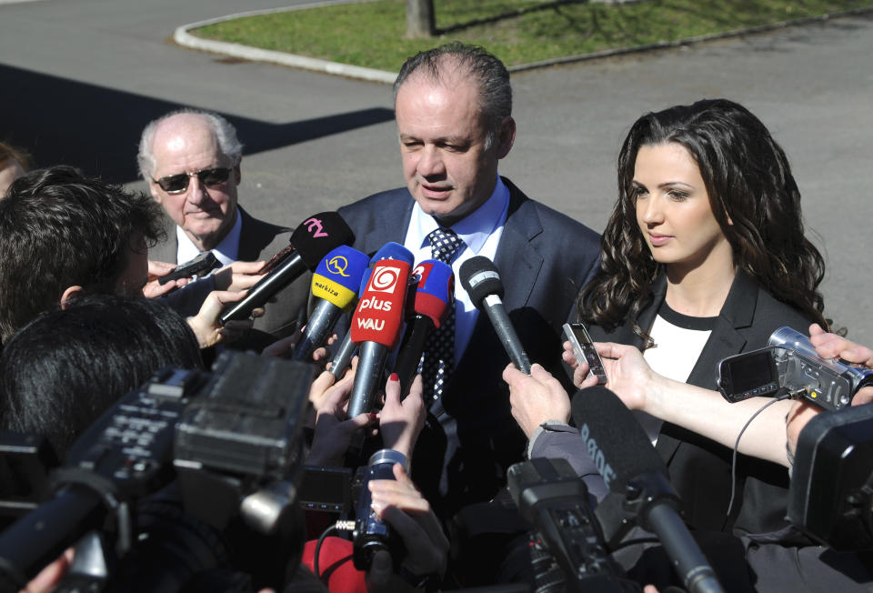 Presidential candidate, businessman and philanthropist Andrej Kiska, centre, speaks to journalists as his father Andrej Kiska Sr., left, and his daughter Natalie Kiskova, right, look on after casting their ballots in the second round of the presidential elections in Poprad, Slovakia, Saturday, March 29, 2014. Kiska´s rival is Slovak Prime Minister Robert Fico. (AP Photo,CTK/Alexander Supik) SLOVAKIA OUT