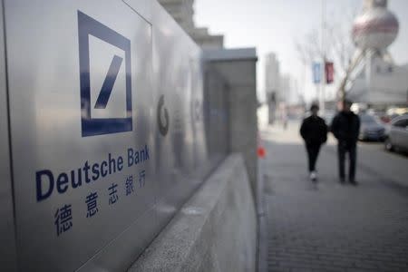 A Deutsche Bank sign is seen outside of a corporate building in Shanghai's financial district February 23, 2011. REUTERS/Carlos Barria