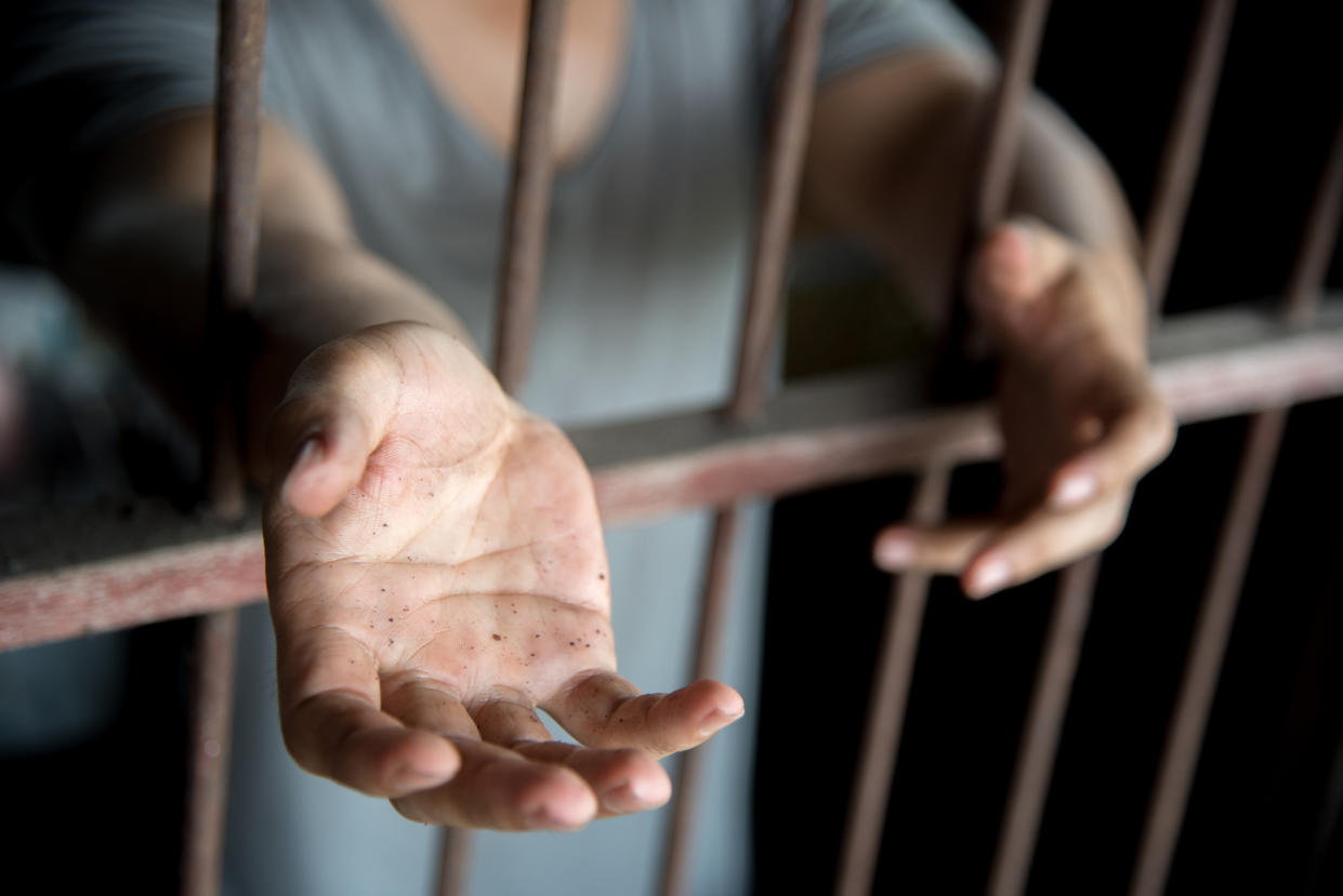 Midsection Of Woman Standing In Prisoner