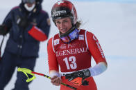 Switzerland's Corinne Suter gets to the finish area after crashing during an alpine ski, women's World Cup downhill race, in Cortina d'Ampezzo, Italy, Friday, Jan. 20, 2023. (AP Photo/Alessandro Trovati)