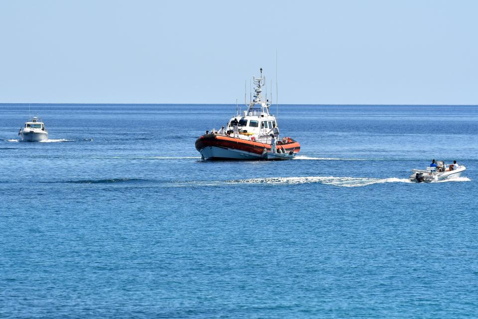 Italy’s Guardia Costiera (Coast Guard) boat with migrants enter in the harbour of the Italian Pelagie Island of Lampedusa on July 30, 2020. Thousands of migrants, asylum seekers and refugees are estimated to have risked the journey across the Mediterranean Sea this year.AFP via Getty Images