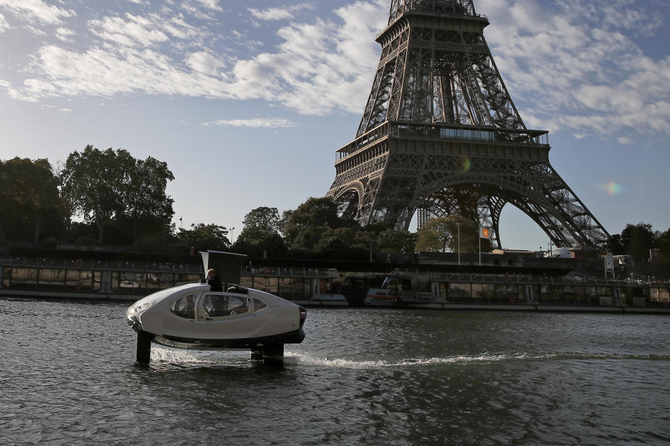 SeaBubbles co-founder Sweden's Anders Bringdal stands onboard a SeaBubble by the Eiffel Tower on the river Seine, Wednesday Sept. 18, 2019 in Paris. Paris is testing out a new form of travel - an eco-friendly bubble-shaped taxi that zips along the water, capable of whisking passengers up and down the Seine River. Dubbed Seabubbles, the vehicle is still in early stages, but proponents see it as a new model for the fast-changing landscape of urban mobility. (AP Photo/Francois Mori)