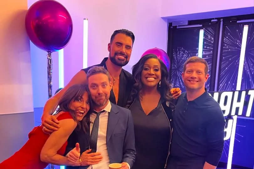 Davina cuddled up with Ricky Wilson in a snap with Rylan, Alison and Dermot