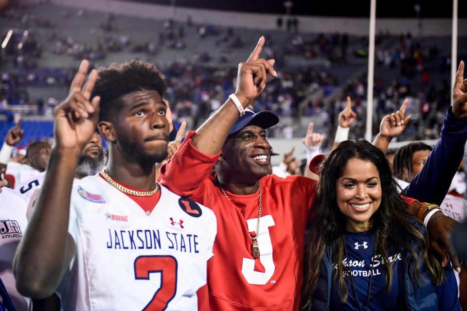 Jackson State's Shedeur Sanders and his father, Tigers coach Deion Sanders, celebrate with Jackson State fans after a victory in the Southern Heritage Classic on Sept. 10.
