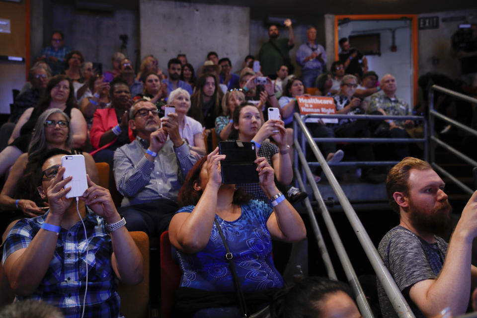 Supporters use their smartphones to record while listening to New York congressional candidate Alexandria Ocasio-Cortez at a fundraiser Thursday, Aug. 2, 2018, in Los Angeles. The 28-year-old startled the party when she defeated 10-term U.S. Rep. Joe Crowley in a New York City Democratic primary. (AP Photo/Jae C. Hong)