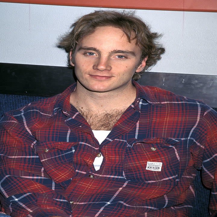 Close-up of Jay in a long-sleeved plaid shirt