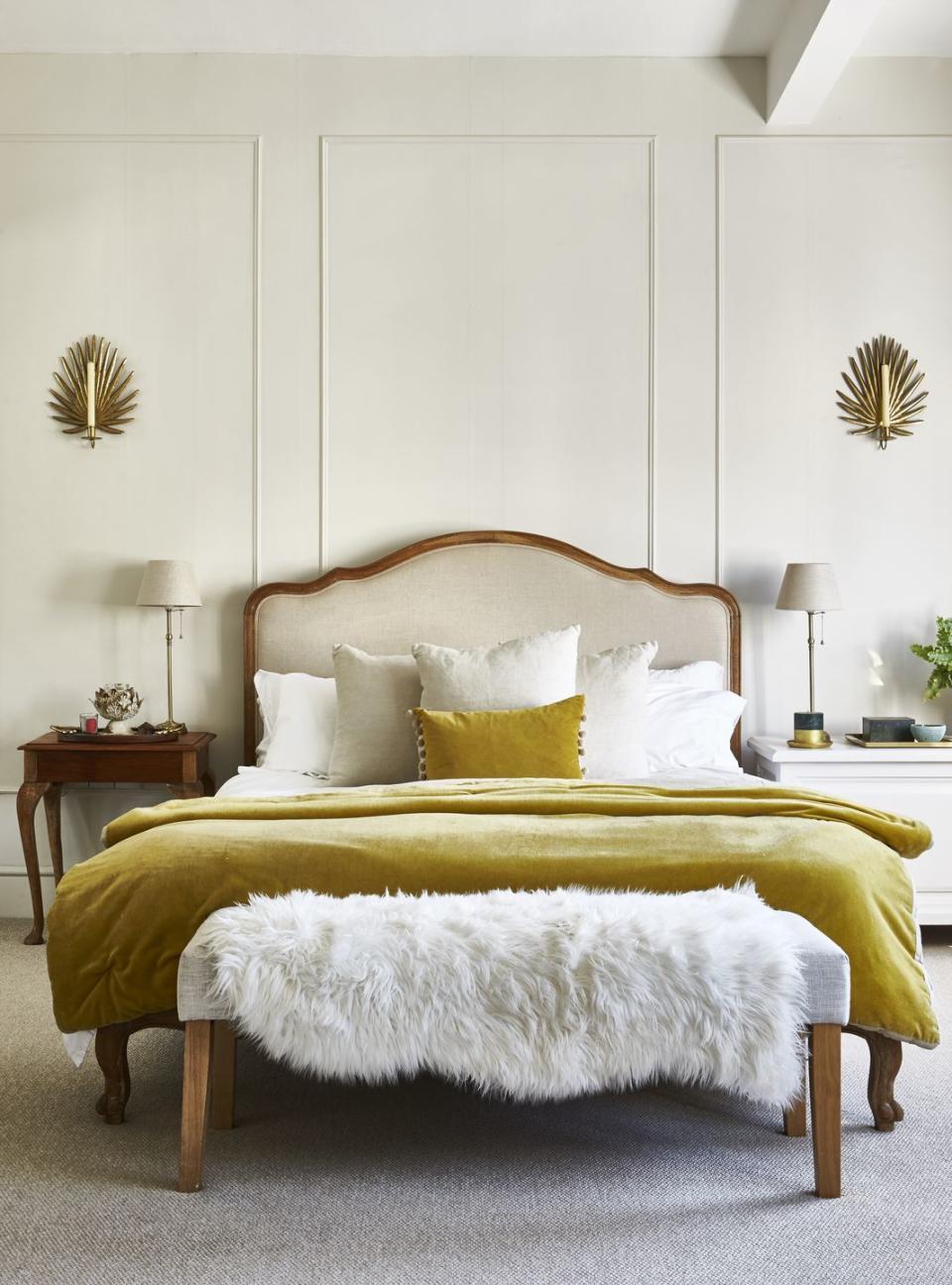 a bed with a yellow and white bed spread