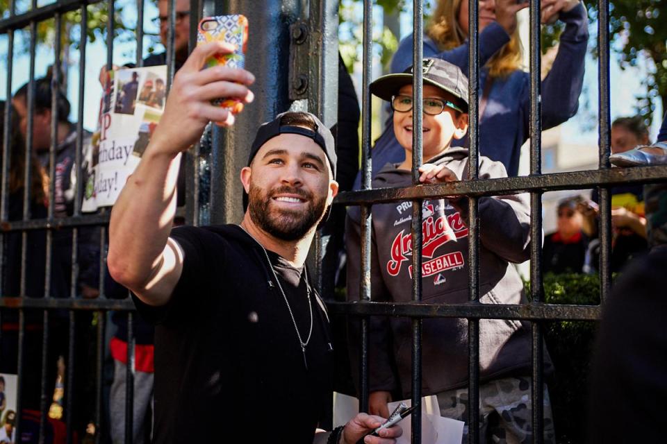 Jason Kipnis poses with a fan at his annual Shoe Toss. (@Indians)