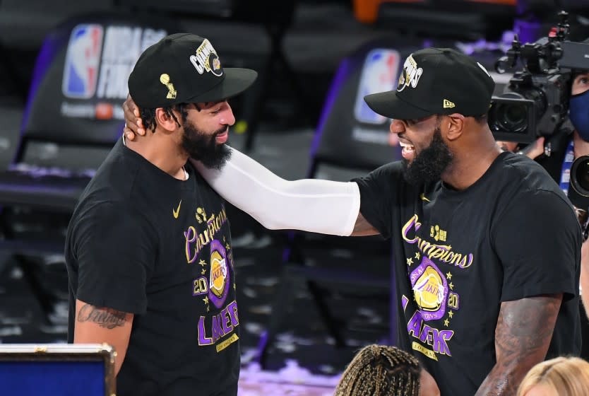 ORLANDO, FLORIDA OCTOBER 11, 2020- Lakers Anthony Davis, left, and LeBron James celebrate the NBA Championship in Game 6 of the NBA FInals in Orlando Sunday. (Wally Skalij/Los Angeles Times)