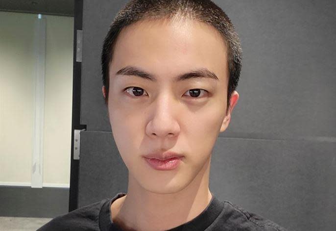 Jin, of  K-Pop band BTS, shows off his freshly shaved head on the K-Pop social media  platform Weverse, Dec. 11, 2022, ahead of his  upcoming military conscription. / Credit: Weverse via AP