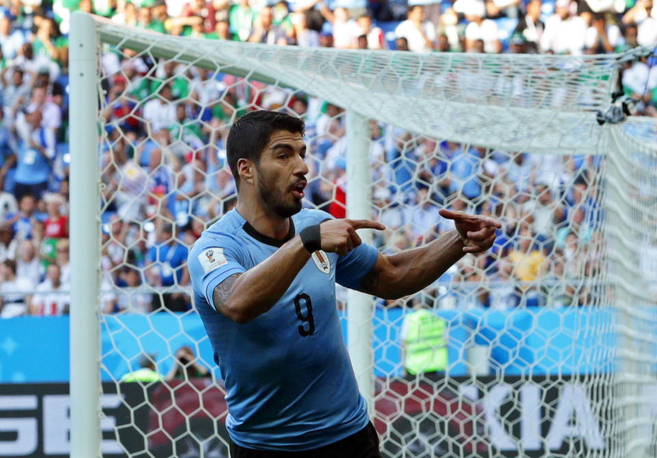 <p>Luis Suarez celebrates scoring his first goal </p>