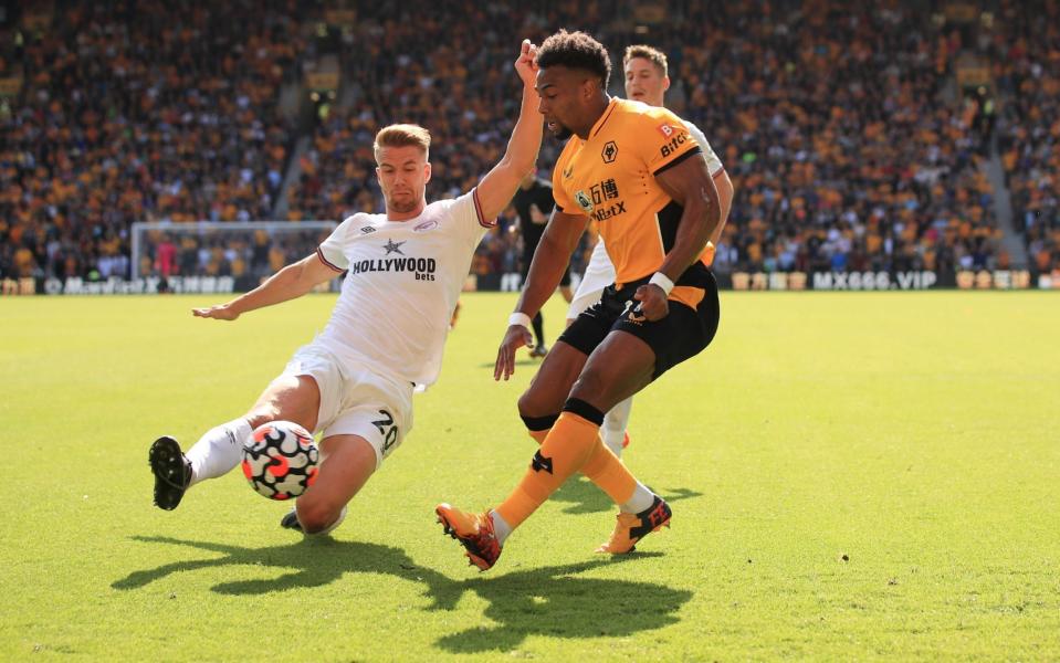 Adama Traore of Wolverhampton Wanderers in action with Kristoffer Ajer of Brentford. - Marc Atkins/Getty Images