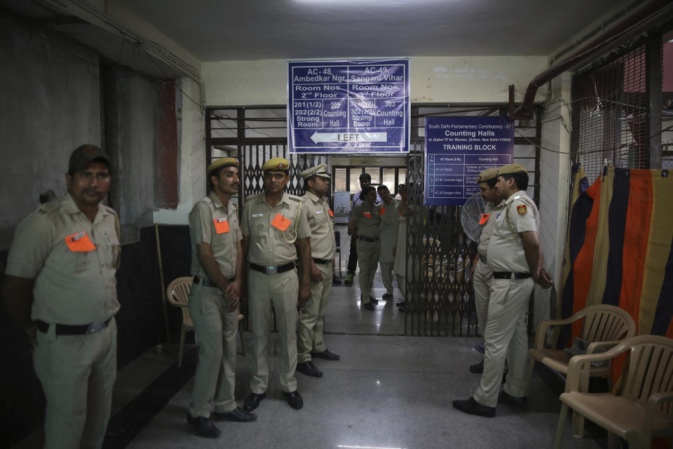 Indian policemen stand guard as counting votes of India's massive general elections begins in New Delhi, India, Thursday, May 23, 2019. The count is expected to conclude by the evening, with strong trends visible by midday. (AP Photo/Manish Swarup)