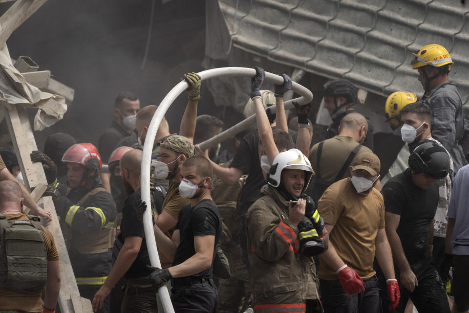 Rescuers, volunteers and medical workers clean up the rubble and search victims after Russian missile hit the country's main children hospital Okhmadit in Kyiv, Ukraine, Monday, July 8, 2024. A major Russian missile attack across Ukraine killed at least 20 people and injured more than 50 on Monday, officials said, with one missile striking a large children’s hospital in the capital, Kyiv, where emergency crews searched rubble for casualties. (AP Photo/Efrem Lukatsky)