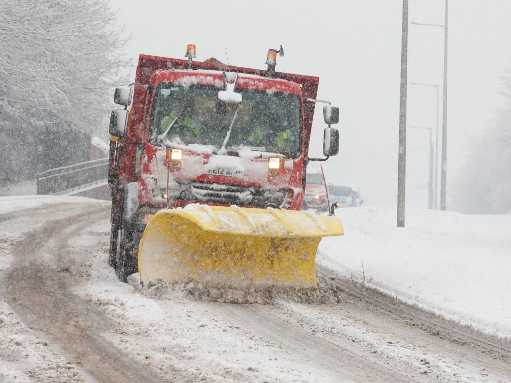 <p>A snow plough and grit spreader works to clear the roads in Barnsley, South Yorkshire. Yellow weather warnings have been issued</p> (Jamie Lorriman)