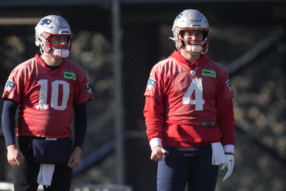 New England Patriots quarterback Bailey Zappe (4) smiles while working out with quarterback Mac Jones during an NFL football practice, Wednesday, Jan. 3, 2024, in Foxborough, Mass. (AP Photo/Charles Krupa)