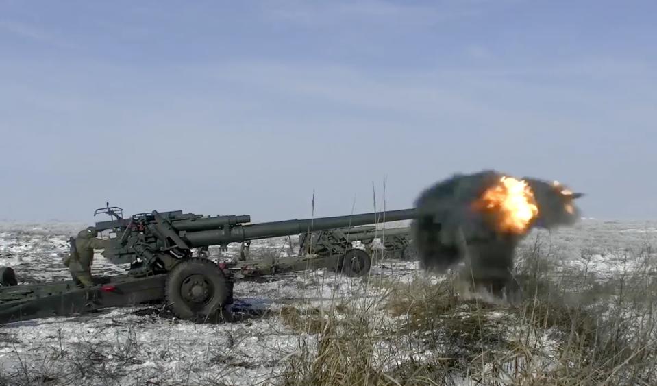 FILE - In this photo taken from video provided by the Russian Defense Ministry Press Service on Friday, Jan. 28, 2022, Russian troops fire howitzers during drills in the Rostov region during a military exercising at a training ground in Rostov region, Russia. The Russian invasion of Ukraine is the largest conflict that Europe has seen since World War II, with Russia conducting a multi-pronged offensive across the country. The Russian military has pummeled wide areas in Ukraine with air strikes and has conducted massive rocket and artillery bombardment resulting in massive casualties. (Russian Defense Ministry Press Service via AP, File)