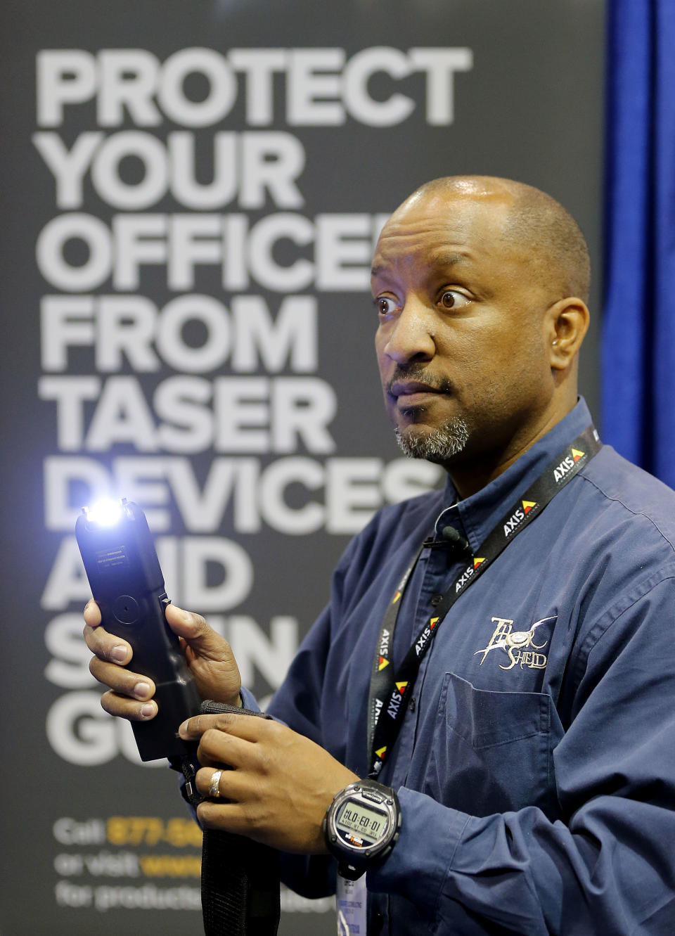 Gregory Williams, of G Squared Consulting, demonstrates an Electroshock weapon at the 8th annual Border Security Expo, Tuesday, March 18, 2014 in Phoenix. The two day event will feature panel discussions, sharing intelligence, and exhibitors displaying high-tech wares aimed at securing lucrative government contracts and private sales. G Squared Consulting creates clothing that is resistant to Electroshock weapons. (AP Photo/Matt York)