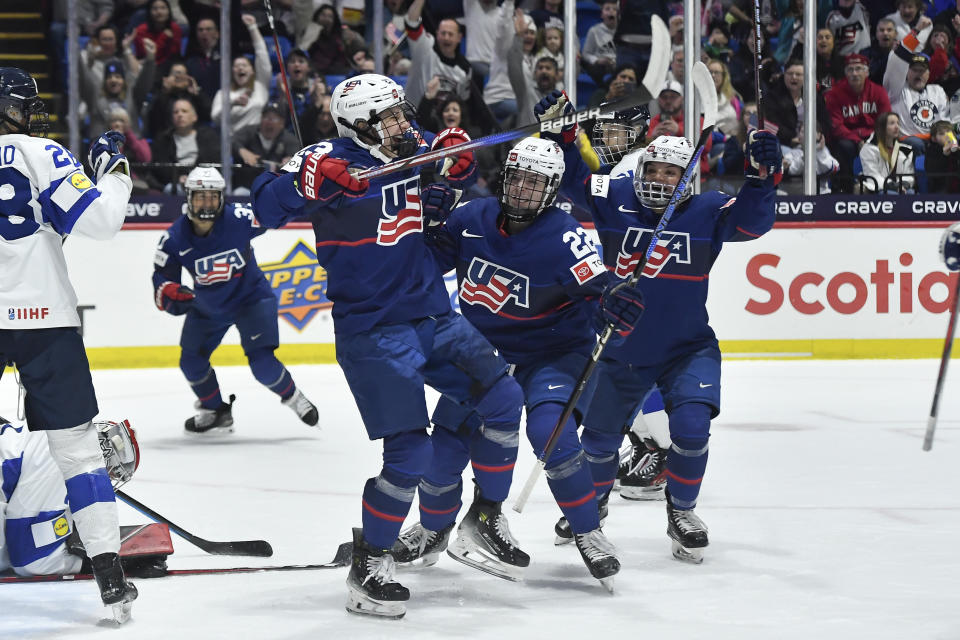 United States forward Hannah Bilka, second from left, celebrates with teammates Tessa Janecke (22) and Cayla Barnes (3) after scoring against Finland during the first period in the semifinals of the IIHF women's world hockey championships Saturday, April 13, 2024, in Utica, N.Y. (AP Photo/Adrian Kraus)