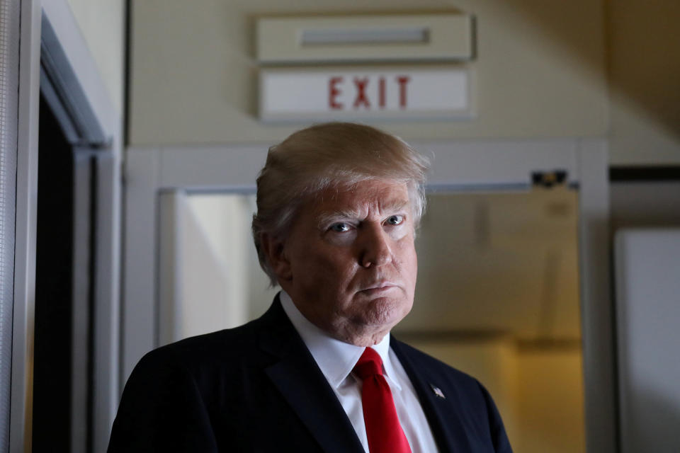 Trump pauses as he talks to journalists who are members of the White house travel pool onboard Air Force One during his flight to Palm Beach, Florida, on&nbsp;Feb. 3, 2017.