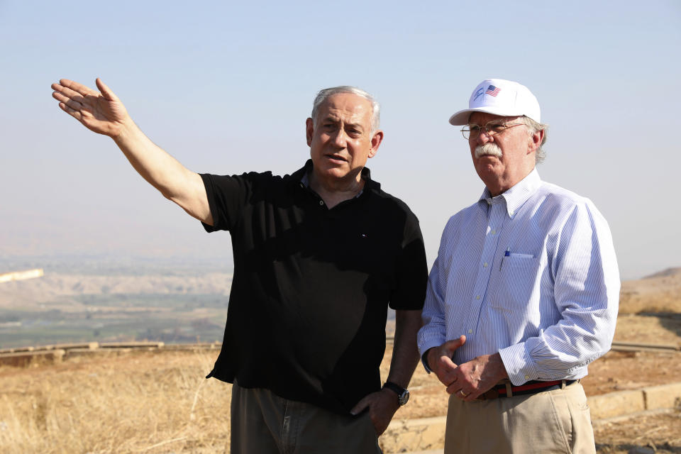 FILE - in this Sunday, June 23, 2019 file photo, US National Security Advisor John Bolton, right, and Israeli Prime Minister Benjamin Netanyahu, visit an old army outpost overlooking the Jordan Valley between the Israeli city of Beit Shean and the Palestinian city of Jericho. Netanyahu vowed Tuesday to begin annexing West Bank settlements if he wins national elections next week. (AP Photo/Abir Sultan, File)