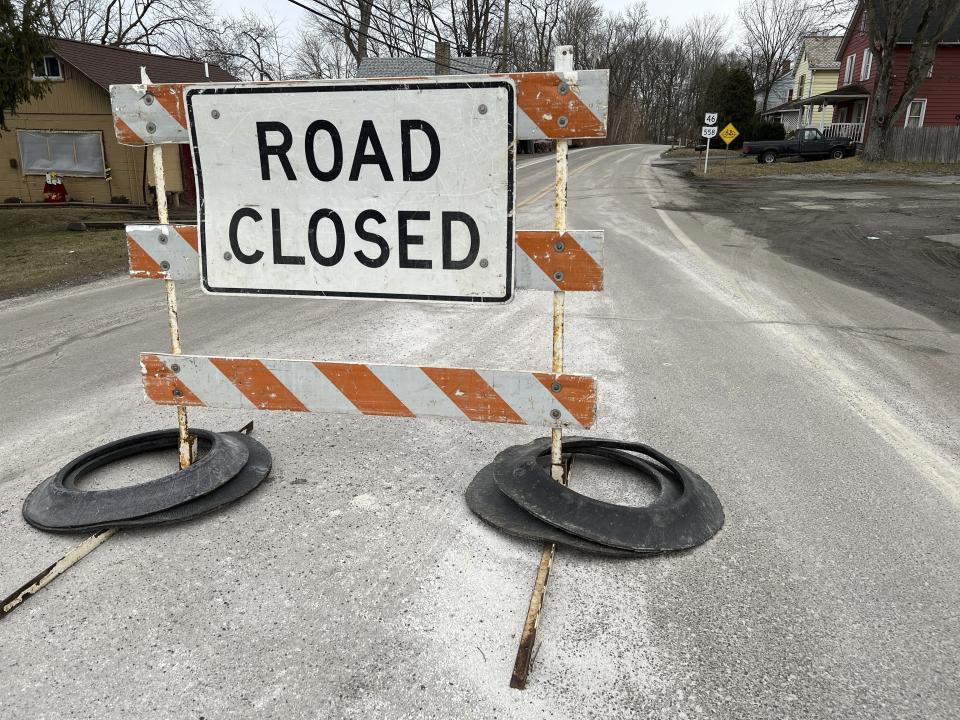 A road closure sign stands in East Palestine, Ohio, on Tuesday, Feb. 7, 2023. About 50 cars, including 10 carry hazardous materials, derailed in a fiery crash Friday night. Ohio and Pennsylvania residents living close to the wreckage were forced to evacuate the area and aren't being allowed into their homes, authorities said Tuesday. (AP Photo/Patrick Orsagos)