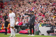 Liverpool's manager Jurgen Klopp, center, gives instructions during the English Premier League soccer match between Liverpool and Tottenham Hotspur at Anfield Stadium in Liverpool, England, Sunday, May 5, 2024. (AP Photo/Jon Super)