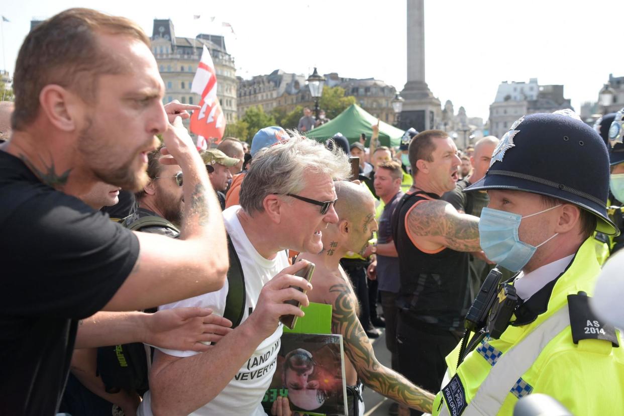 Police supervise protestors at an anti-vax rally in central London: AFP via Getty Images