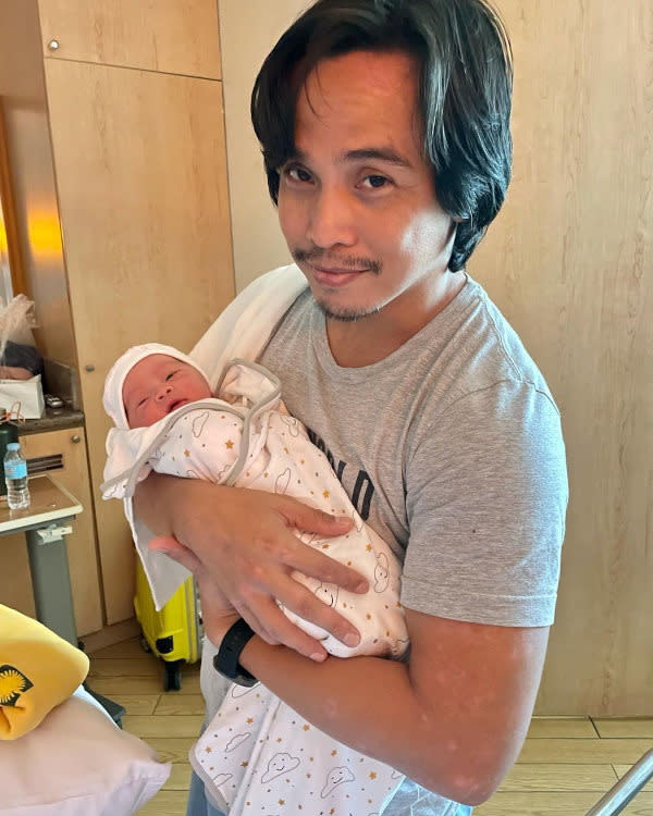 Proud father Joey Ramirez cradling baby Osseah