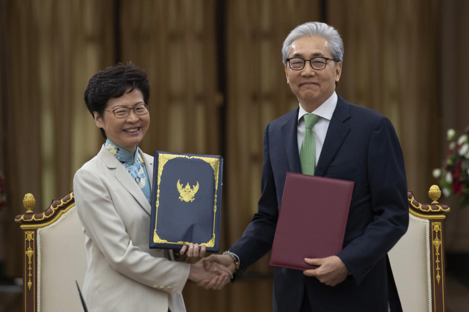 Hong Kong Chief Executive Carrie Lam, left, and Thailand 's Deputy Prime Minister Somkid Jatusripitak pose after signing memorandum of understanding on strengthening of economics relations at government house in Bangkok, Thailand, Friday, Nov. 29, 2019. (AP Photo/Sakchai Lalit)