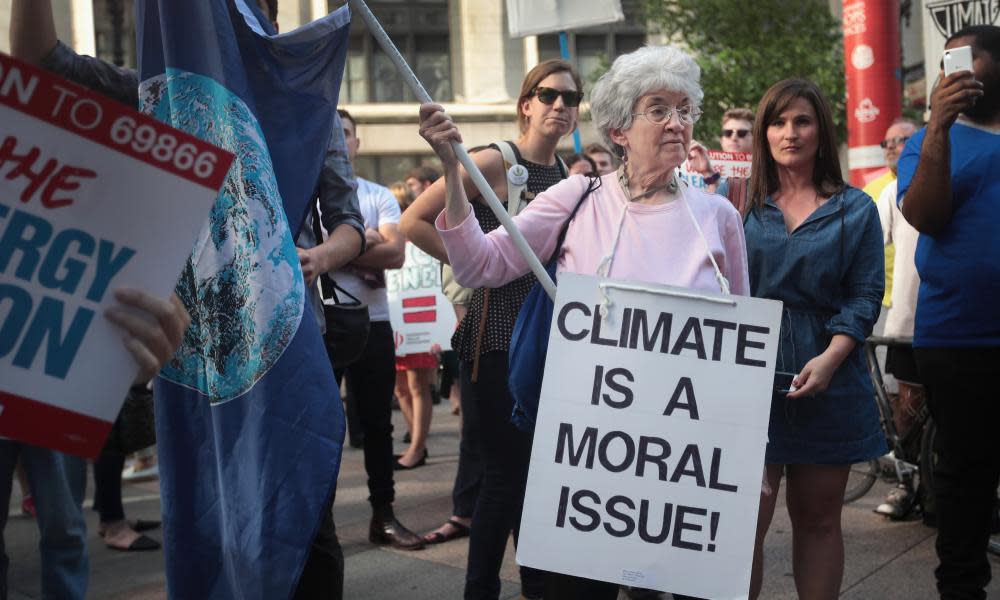 Demonstrators protest against President Donald Trump’s decision to exit the Paris climate change accord.