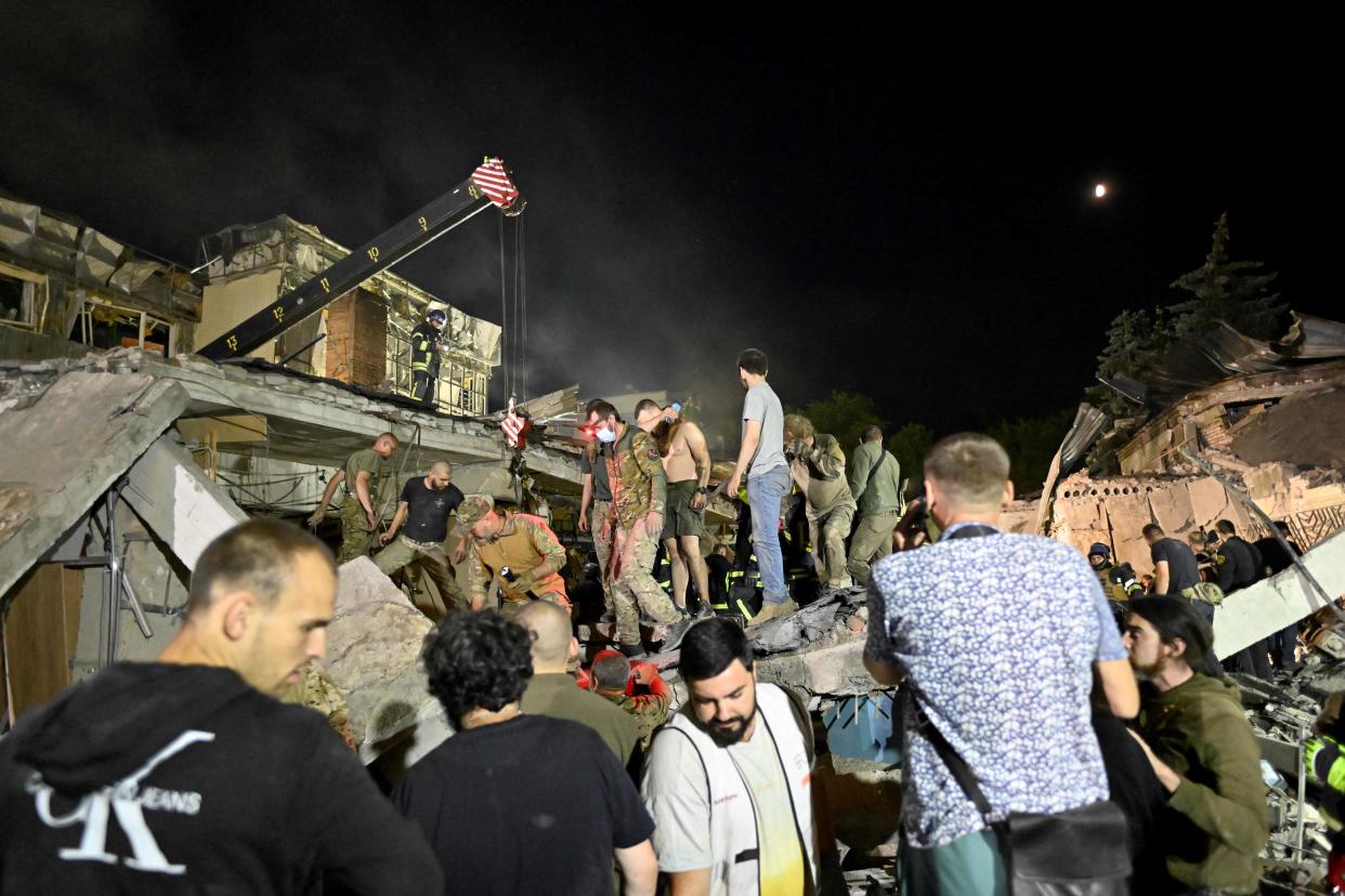 Rescuers and volunteers work to rescue people from under the rubble after Russian missile strike hit a restaurant and several houses in Kramatorsk (AFP via Getty Images)