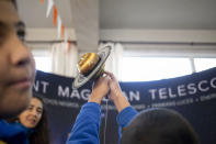 Blind school children take part in a sensorial experience with tools created by NASA and Edinburgh University to experience an eclipse, during an event in the Helen Keller school in Santiago, Chile, Tuesday, June 25, 2019. The event comes exactly one week ahead of a total solar eclipse which is set to be fully visible in various South American countries, including Chile. (AP Photo/Esteban Felix)