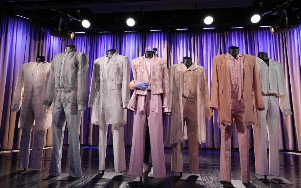 Outfits worn by the Korean pop group BTS for their "Proof Door" concept photo are primped at the K-pop HYBE Exhibit at the Grammy Museum, Friday, June 28, 2024, in Los Angeles. (AP Photo/Chris Pizzello)